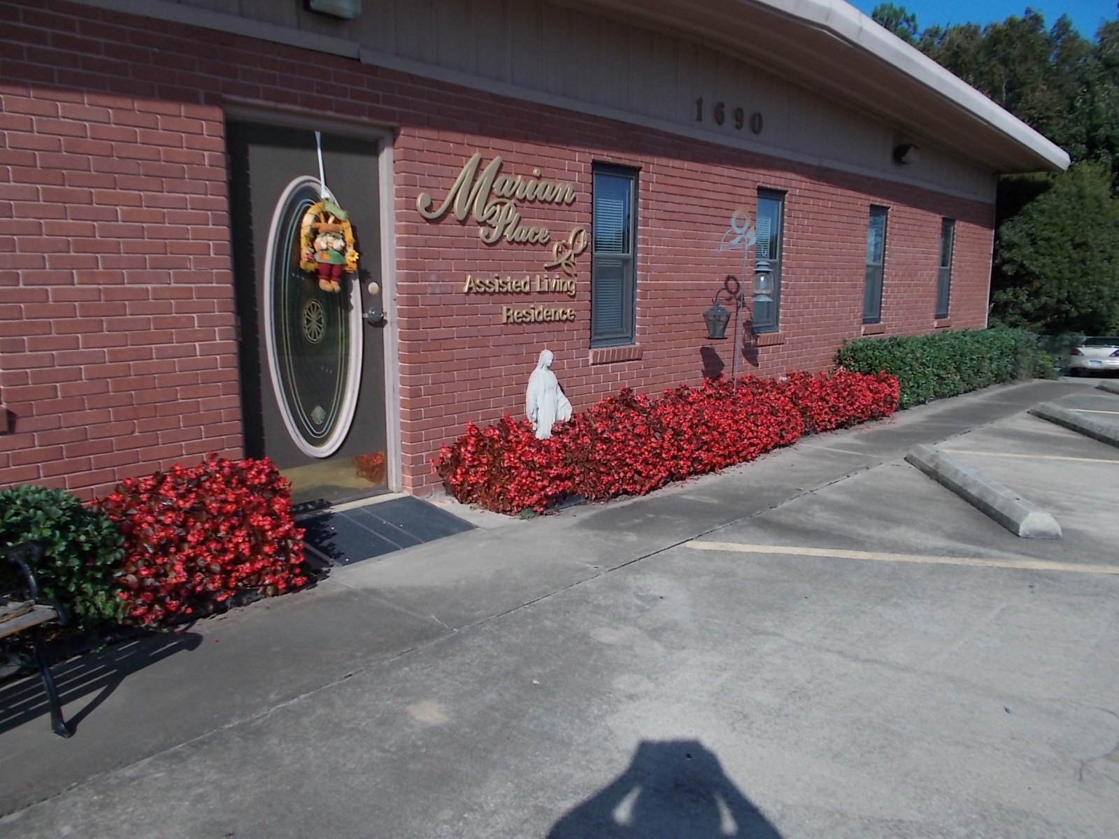 The front of Marian Place lined with red begonias